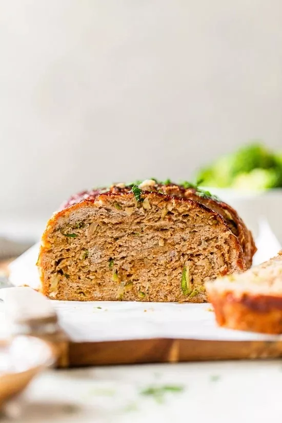 Grated zucchini added to turkey meatloaf makes it the juiciest. It's simple to make this meatloaf: just combine all the ingredients, form it into a loaf, and bake